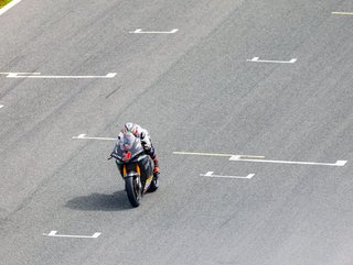 The Ducati electric motorcycling racing over the grid on the MotoE track.