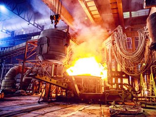 Scrap metal being poured into an electric arc furnace, which is a far cleaner way of making steel than using coke-fulled furnaces.