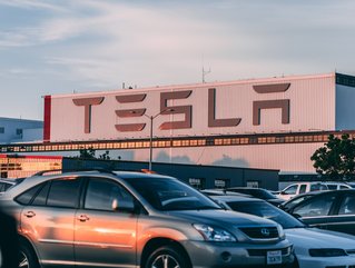Cars parked in front of Tesla company building. Credit: Craig Adderley