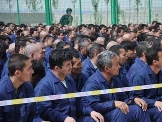 Some of the estimated 570,000 Uyghur people from Xinjiang province, China, who are involved in forced labour. Here they are pictured in a internment camp. Screening suppliers is vital if businesses are to ensure no such human rights violations exist in their supply chain.