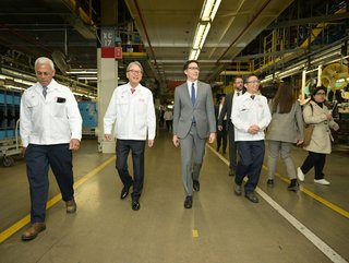 Justin Trudeau, Prime Minister of Canada (centre) walks with Toshihiro Mibe, President and CEO of Honda Motor Co. (second from left)., at Honda of Canada Mfg., where the company announced a $15-billion investment to build a comprehensive electric vehicle value chain in Canada. (Credit: CNW Group/Honda Canada Inc.)