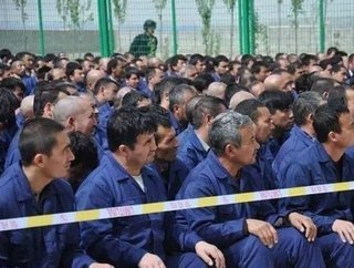 Some of the estimated 570,000 Uyghur people from Xinjiang province, China, who are involved in forced labour. Here they are pictured in a internment camp.