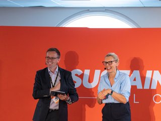 Sue Fennes from WeAre8 on stage with Neil Perry at Sustainability LIVE London 2022